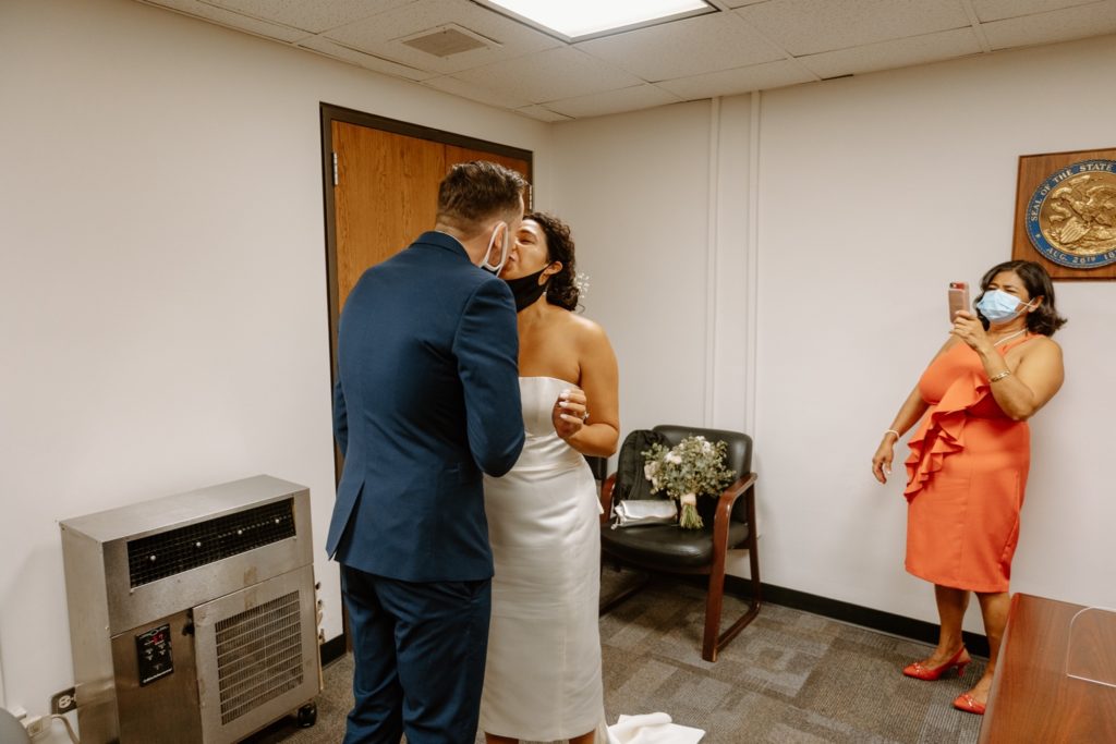 Bride and groom share first kiss at elopement in Chicago City Hall