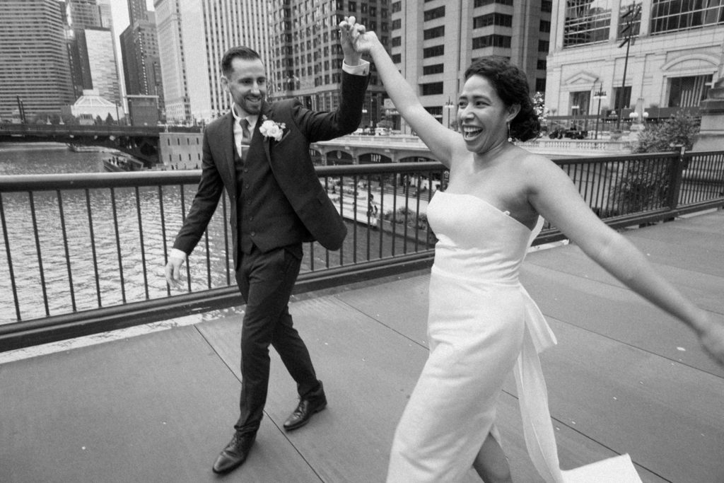 Bride and groom celebrate their elopement in front of Chicago River