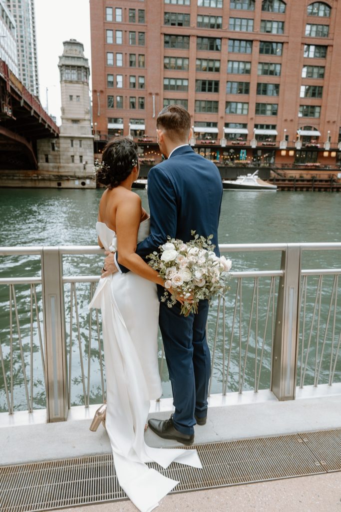 Bride and groom looking out over the Chicago River after elopement