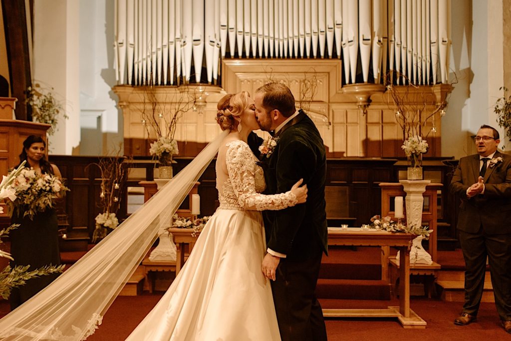 Bride and groom first kiss at Jacob Henry Mansion wedding