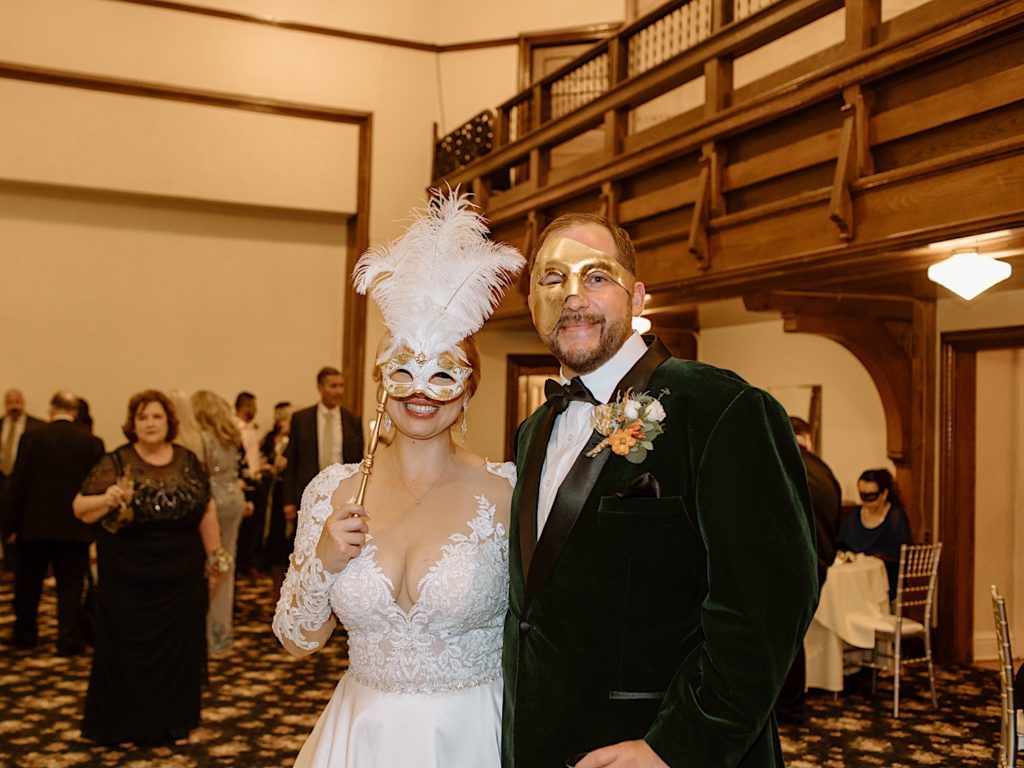 Bride and groom wear masks for wedding reception at Jacob Henry Mansion
