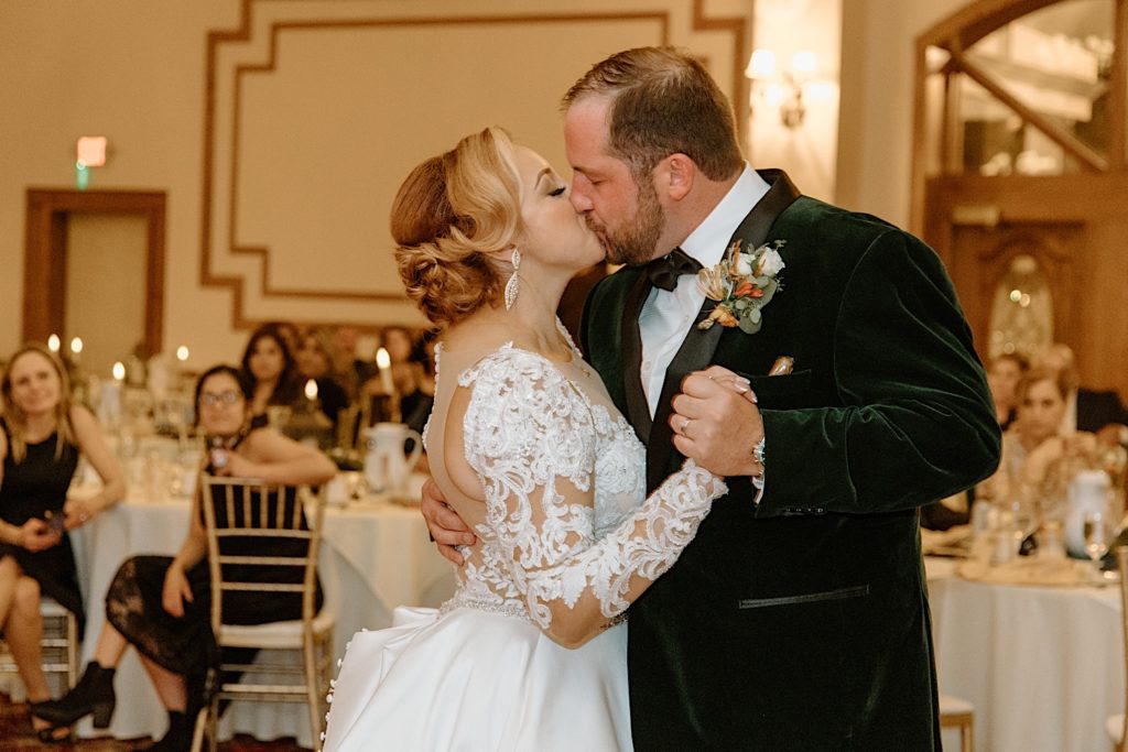 Bride and groom kiss during wedding reception at Jacob Henry Mansion
