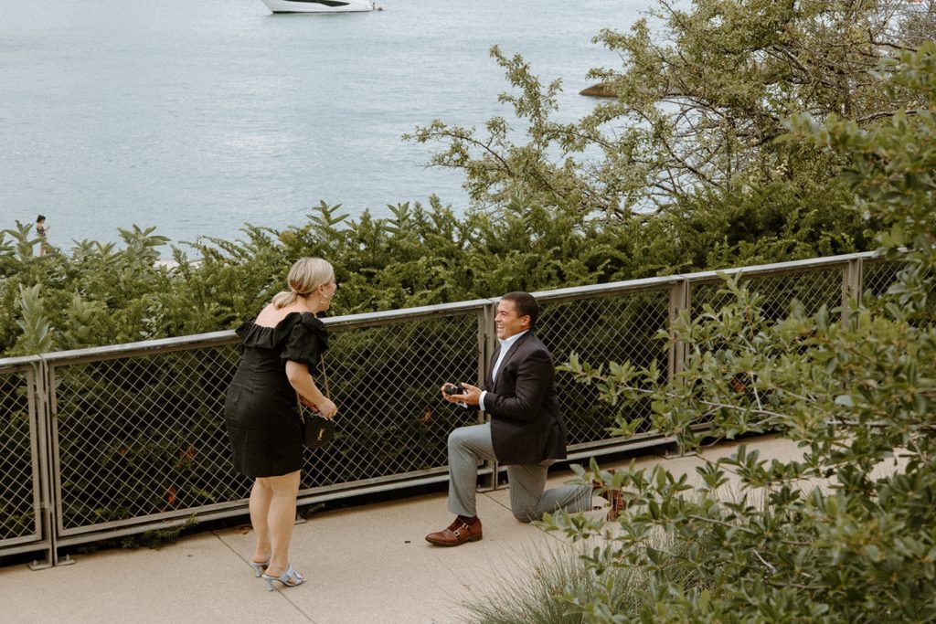 Couple getting engaged by the water front