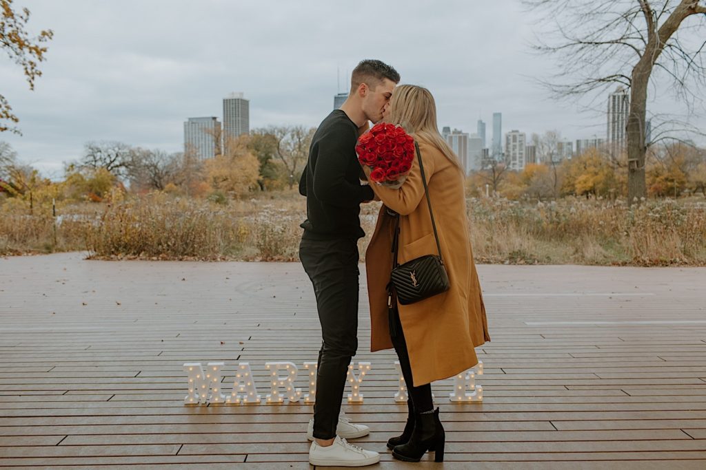 Couple kisses after perfectly planned proposal