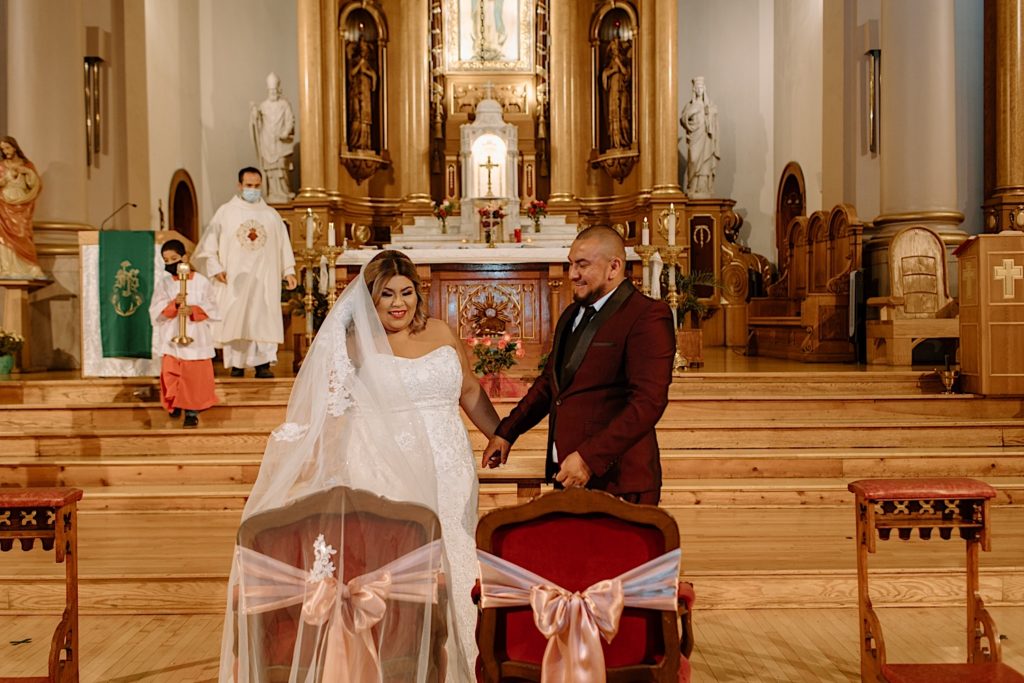 Bride and groom at wedding in Lady of Tepeyac church in Chicago