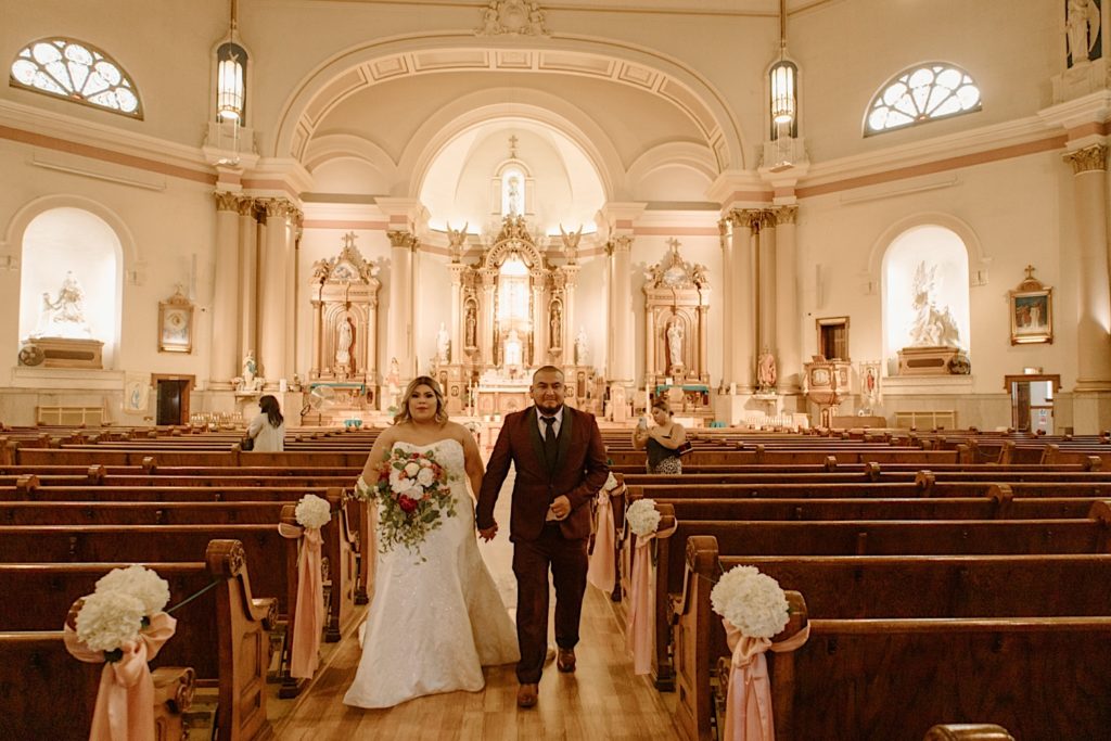 Bride and groom walking out after Chicago church wedding